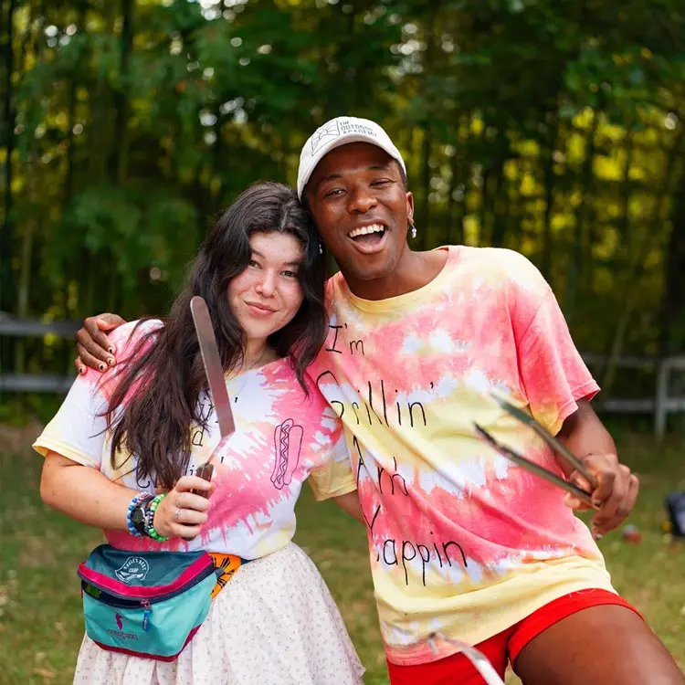 Girl and guy pose for photo in tie-die