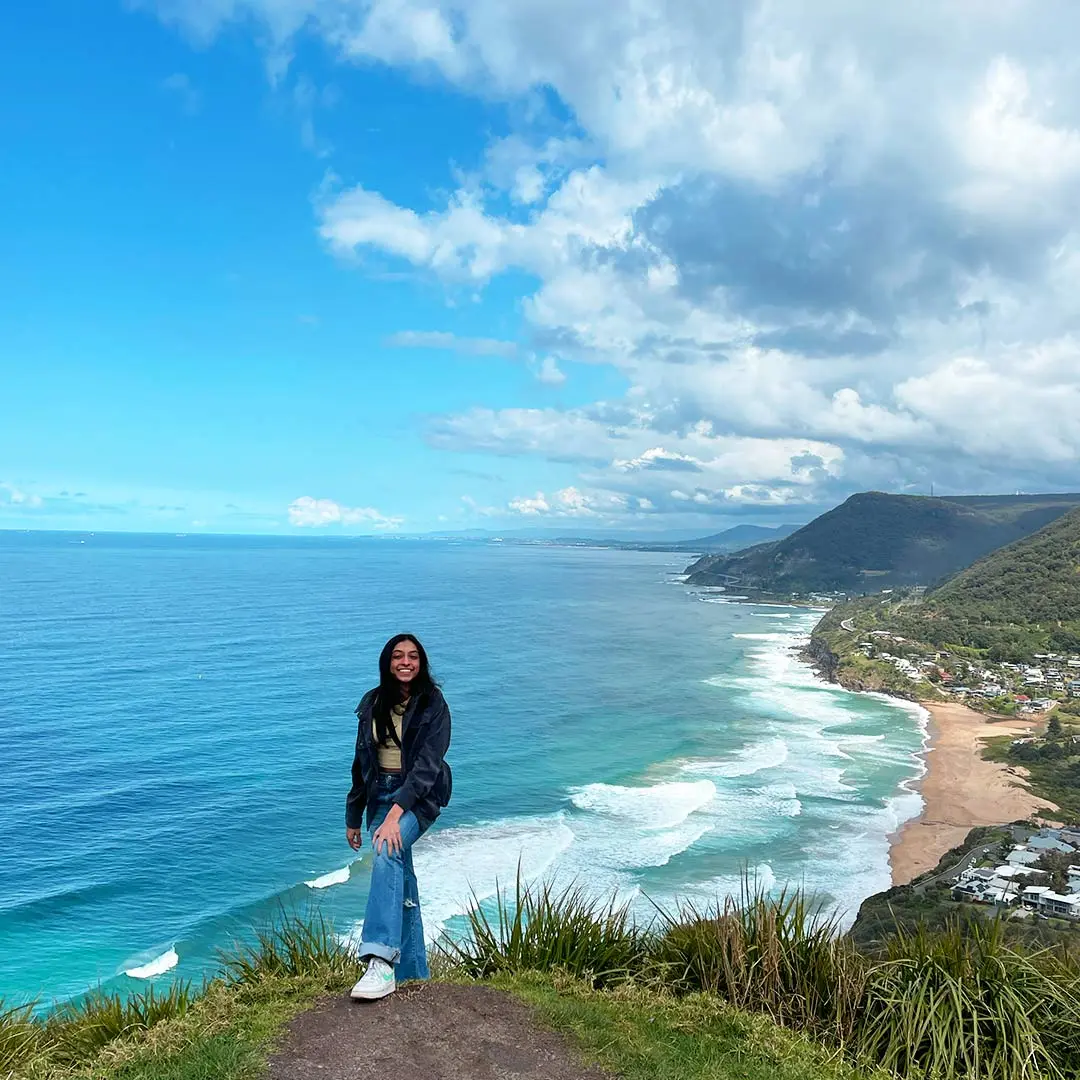 Girl on cliff at coast